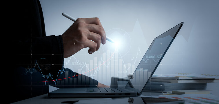 businessman trading in stock market exchange on virtual screen in office workplace signing investment documents and money management with trading chart financial planning for saving and passive income