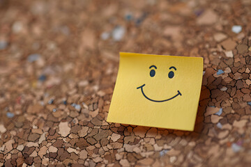 Smiley signs on yellow paper note. 