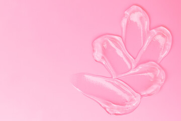Gel smears cosmetic texture on pink background with space for text