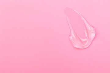 Gel smears cosmetic texture on pink background with space for text