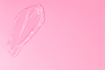 Gel smears cosmetic texture on pink background with space for text