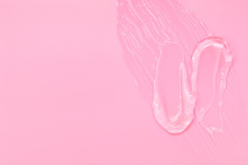 Gel smears cosmetic texture on pink background with space for text
