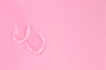 Gel smears cosmetic texture on pink background with space for text