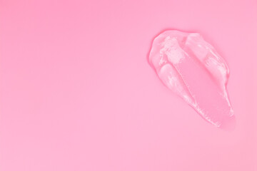 Gel smears cosmetic texture on pink background with space for text