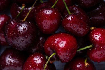 Fresh red cherries fruit. Fresh organic berries with leaves macro. Large collection of fresh red cherries. Ripe cherries background. Lot of red ripe cherries close up with water drops.