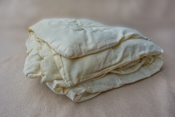 Old yellow bed duvet full of mites.