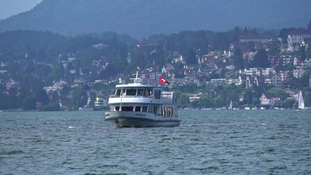 Passenger ship named Pfannenstiel arriving at pier at Swiss City of Z&uuml;rich on a sunny summer day. Movie shot June 27th, 2024, Zurich, Switzerland.