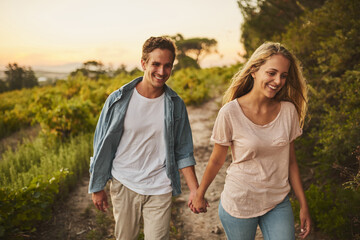 Smile, couple and holding hands at farm in nature for agriculture business in countryside. Farmer, man and woman together at field for love, support or bonding at garden on walk to travel outdoor