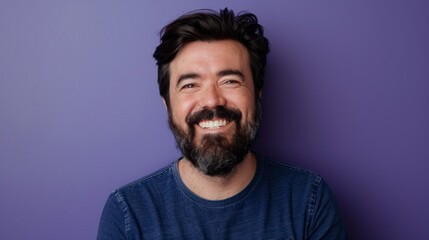 Obraz premium middle aged man with beard smiling at the camera on purple background in high resolution and quality