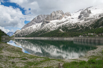 View of Lake Fedaia is a lake in the Dolomites, located just west of Fedaia Pass. It is located in the municipality of Canazei, in the province of Trento, Italy