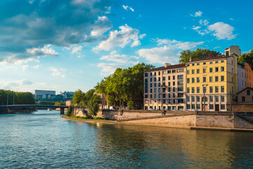 Landscape of the Saône River in Lyon, France, with buildings in the riverbanks at sunset