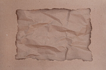 Torn Brown Paper Frame. Craft paper background with square hole for content or promotion