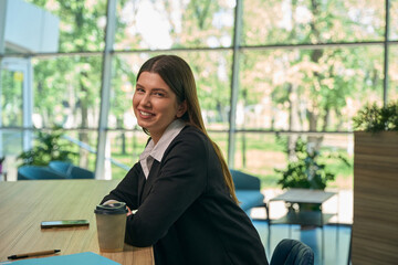 Girl sitting at the table and looking at the camera