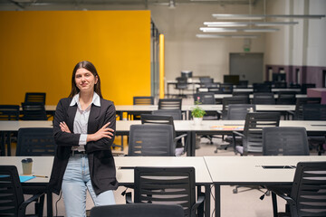 Girl in a jacket stands near her desk