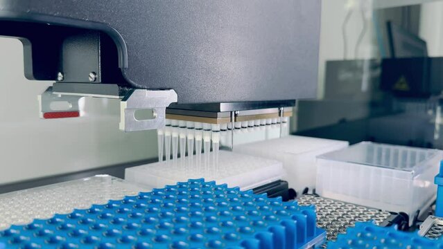 high-tech laboratory automation system, mechanical robotic arm working on blue plate with multiple wells. sequencing research and genetic tests. Science research, laboratory work, and medical testing 