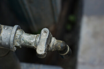 Old model worn iron water tap