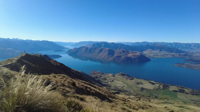 Aerial shot of a majestic lake nestled amidst scenic Roys Peak in New Zealand