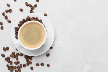 Cup of coffee on concrete background, top view
