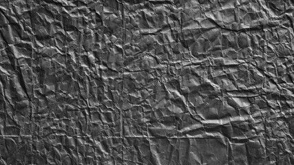 Dark grey crumpled bumpy paper texture