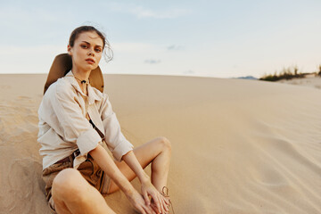 Woman Sitting on Sand Dune in Desert Under Clear Blue Sky on Sunny Day, Serene and Peaceful Scene