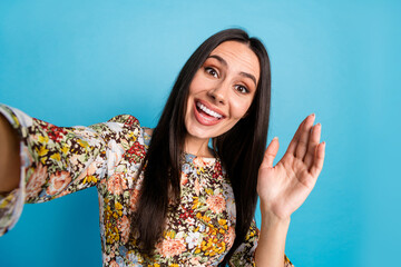 Photo of cheerful pretty lady dressed print clothes recording video vlog waving arm hi empty space isolated blue color background