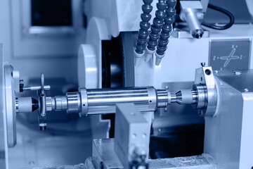 Blue toning, CNC turning production of shafts on factory. Heavy industry background, machine for cut metal