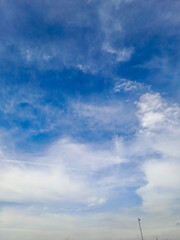 Elevated Spirits: Lone Enthusiast Pilots a Vibrant Kite Against the Canvas of a Clear Azure Sky