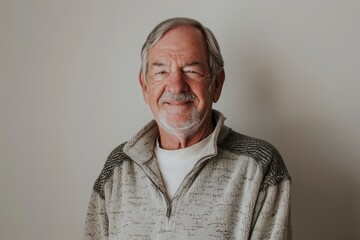 Obraz premium Portrait of a glad caucasian man in his 70s dressed in a comfy fleece pullover in white background