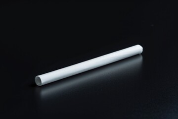 A close-up view of a cigarette on a table, ready for ignition