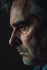 Obraz premium Close-up shot of a person's face illuminated only by faint light