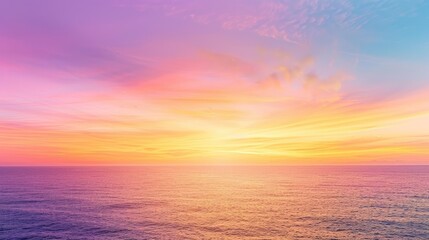 Obraz premium Colorful gradients paint the sky at sunset, featuring vibrant shades of purple, orange, and yellow over a tranquil sea horizon.