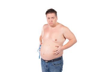 Fototapeta premium Funny fat man on a diet. Guy posing on a white background.