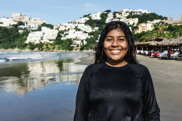 portrait of young latin woman at beach in Acapulco Mexico Latin America, hispanic female at pacific...