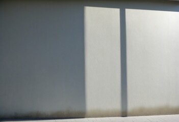 Fototapeta premium A geometric composition of black-and-white shadows overlaid on a smooth concrete wall surface