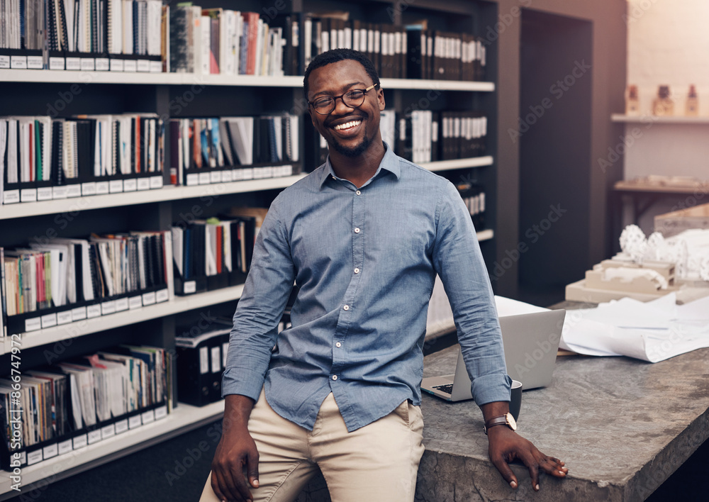 Canvas Prints Black man, portrait smile and standing by desk with confidence for startup, construction business and laptop in office. African guy, happy and entrepreneur for architecture job, design and computer