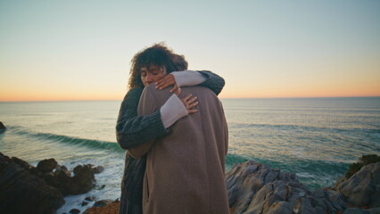 Romantic lovers dating ocean evening beach. Gentle man embracing woman at sunset