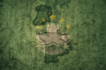 map and flag of Macau on a old vintage crack paper background .