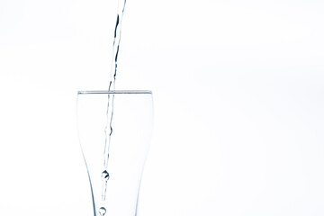 Pouring water into a glass on a white background. Close-up image,Glass of drinking water isolated on white background