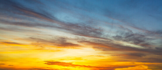 Clouds and sky in the evening,Real majestic sunrise sundown sky background with gentle colorful clouds without birds. Panoramic, big size