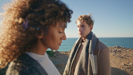 Man woman reflecting contemplation at beachside dialogue closeup. Sad people
