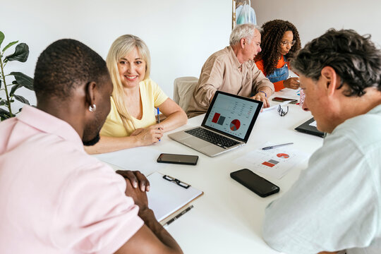Diverse group of professionals collaborating in a modern coworking space