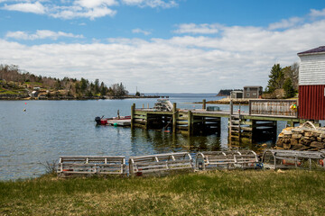 traditional lobster traps made of wood and net in a beautiful sheltered cove on nova scotia's south...