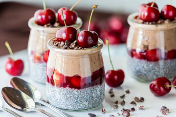 Black forest chia puddings topped with fresh cherries and cacao nibs.