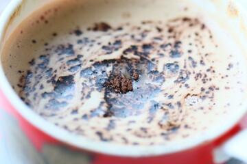 A close-up view of a cup of coffee on a table, perfect for use in food or beverage advertising
