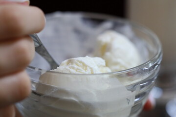 A person enjoying a bowl of ice cream, a sweet treat on a warm day or a perfect dessert after dinner