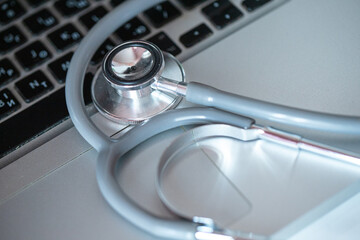 Stethoscope placed on a computer keyboard, highlighting the accessibility of medical expertise...
