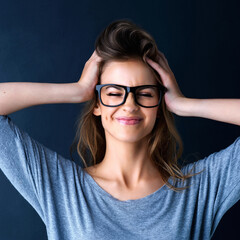 Fototapeta premium Smile, glasses and silly girl in studio with fashion, touching hair and optometry for vision. Face, gen z or young woman with prescription eyewear, confidence and happiness by dark background
