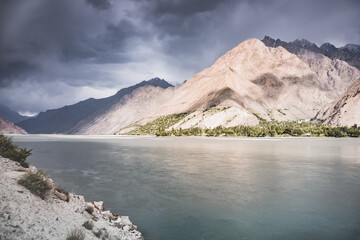 Rocky Tien Shan mountain range and Panj river in Tajikistan in Pamir in cloudy weather