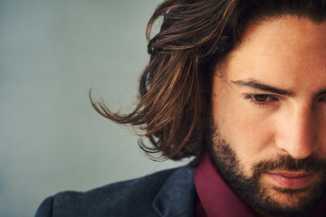 Face, space and thinking with man in studio isolated on gray background for masculine style closeup. Idea, planning or vision and confident model with beard on mockup for problem solving or thought