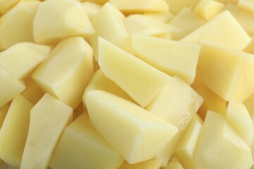 Peeled fresh raw potatoes as background, closeup